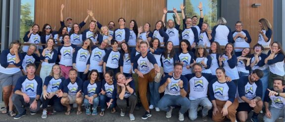 Cascades Academy staff members in branded shirts posing for group picture