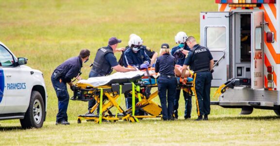 EMS first responder response team helping injured person in field paramedic ambulance