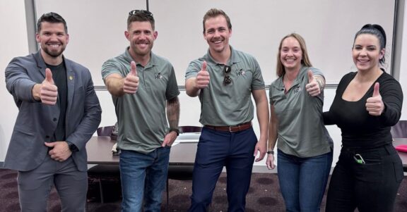 home of record project team members at event lined up giving thumbs up