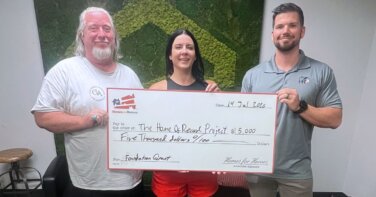 JK Veronica Gary holding big check Homes for Heroes Foundation grant for Home of Record Project