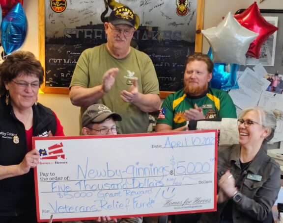Newby-ginnings staff specialist Kathy Colkitt Homes for Heroes check presentation