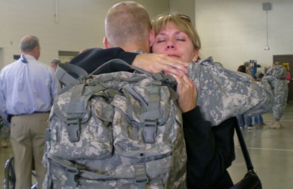 US military service member returning saying goodbye to loved one