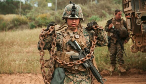 US Marine carrying chain parked rig side of muddy road by joel rivera camacho C8LdCwlkpqQ Unsplash